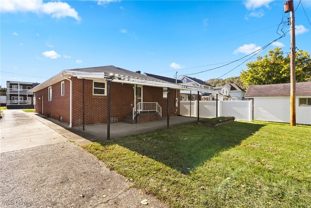 rear view of property with a patio area, a yard, and a pergola