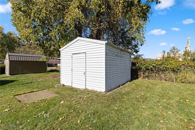 view of outbuilding featuring a lawn