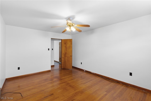 empty room featuring hardwood / wood-style floors and ceiling fan