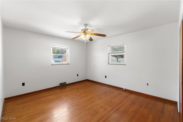 unfurnished room with ceiling fan and hardwood / wood-style flooring