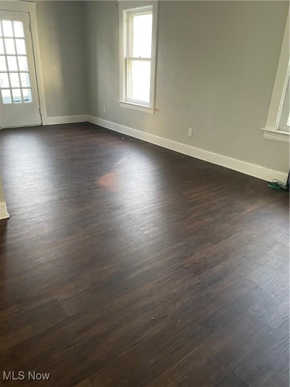 spare room with dark wood-type flooring