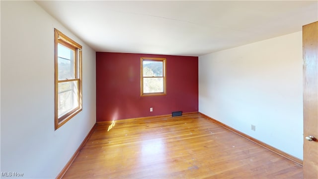 empty room with light hardwood / wood-style floors