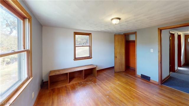 unfurnished room with a wealth of natural light and light wood-type flooring