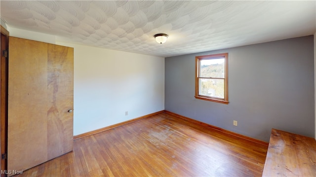 unfurnished room with hardwood / wood-style floors