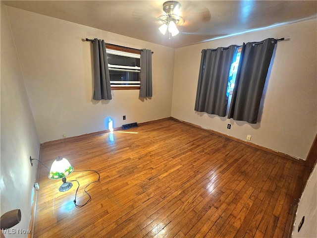 unfurnished room with hardwood / wood-style floors and ceiling fan