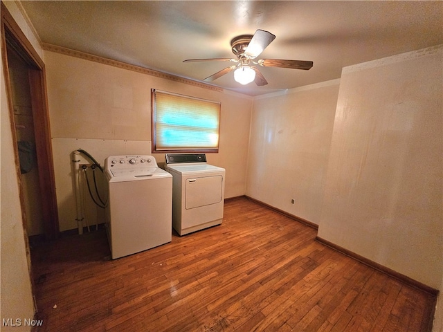 laundry area with ornamental molding, washer and dryer, wood-type flooring, and ceiling fan