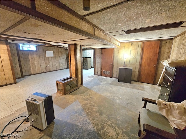 basement featuring wood walls