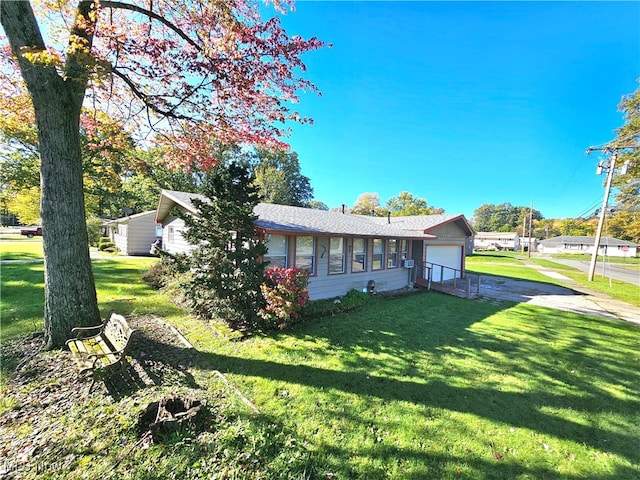 view of front of house with a front lawn and a garage