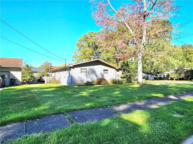 view of property exterior with a lawn