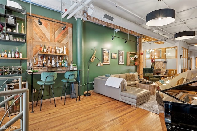 bar with wood-type flooring