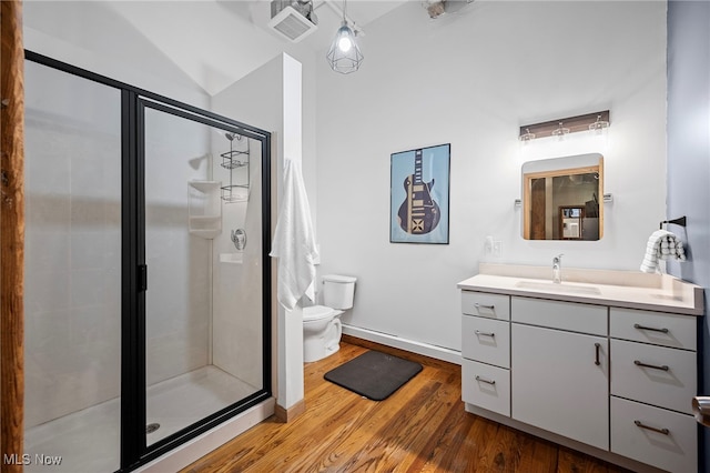 bathroom featuring vanity, toilet, an enclosed shower, and hardwood / wood-style floors