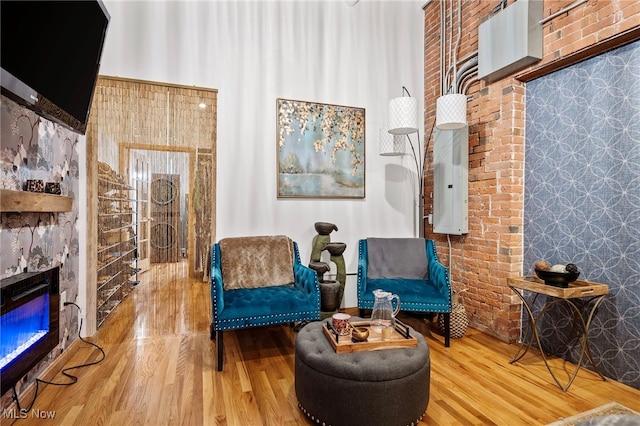 living area with a high ceiling and wood-type flooring