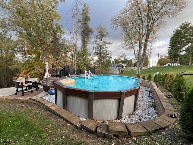 view of swimming pool with a yard and a patio