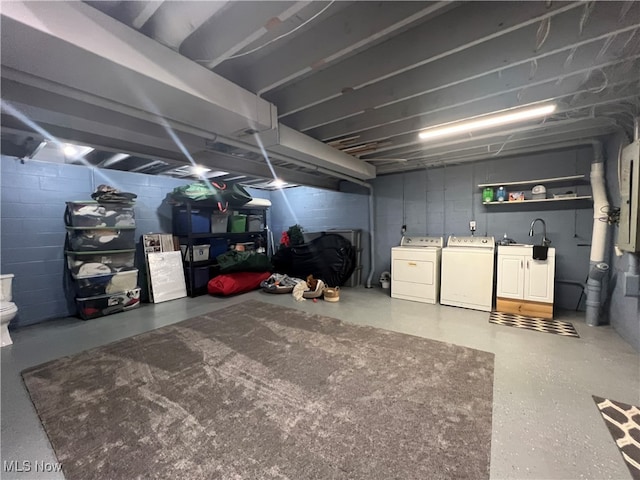 basement with sink and independent washer and dryer