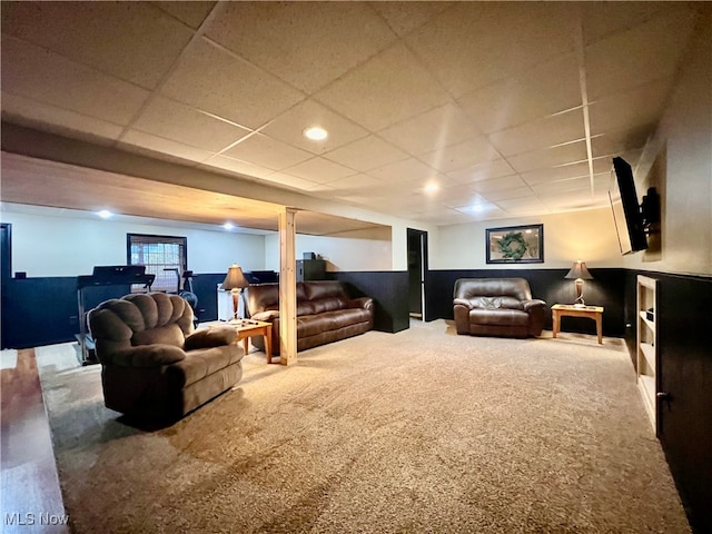 carpeted living room with a drop ceiling