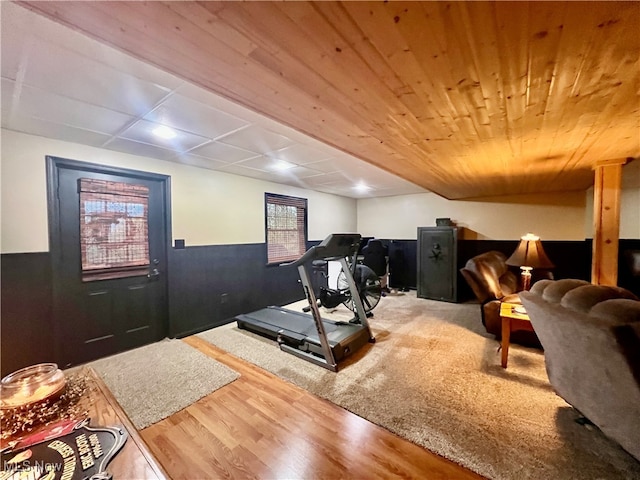 exercise room featuring hardwood / wood-style flooring and wooden ceiling