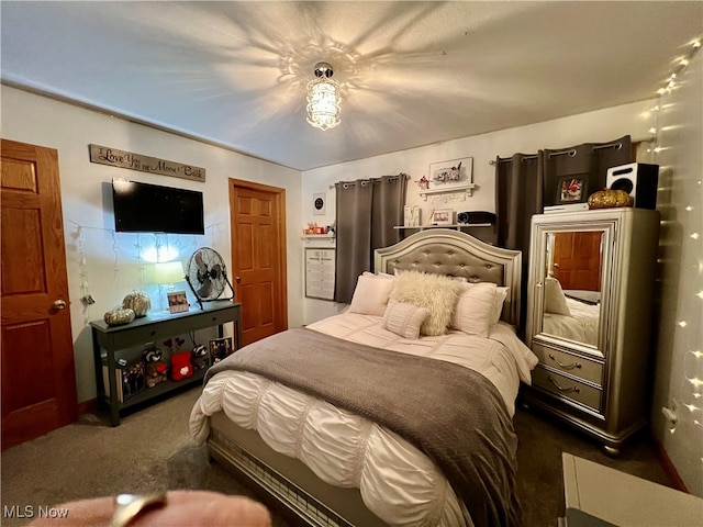 bedroom featuring dark carpet