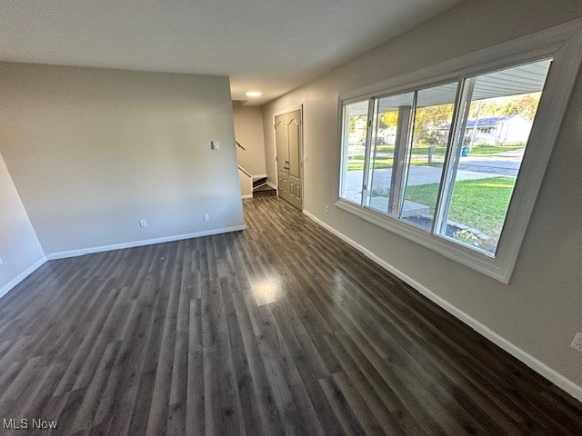 spare room featuring dark hardwood / wood-style flooring