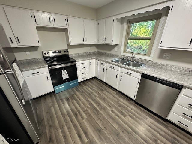 kitchen featuring sink, appliances with stainless steel finishes, dark hardwood / wood-style floors, and white cabinets