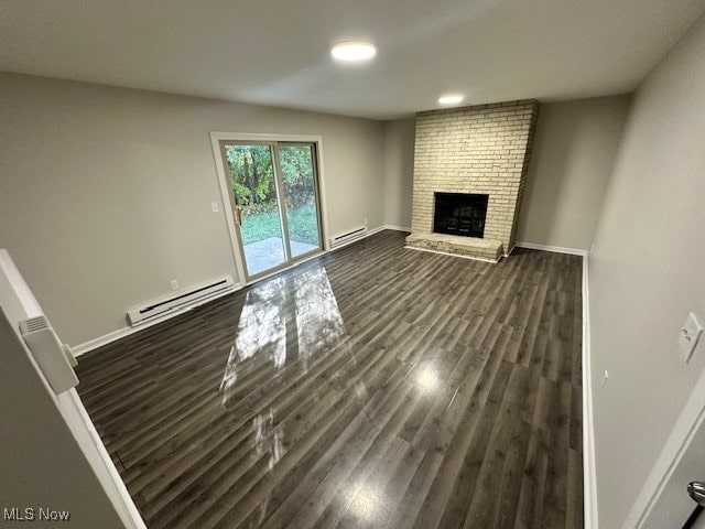 unfurnished living room featuring a brick fireplace, a baseboard radiator, and dark hardwood / wood-style flooring