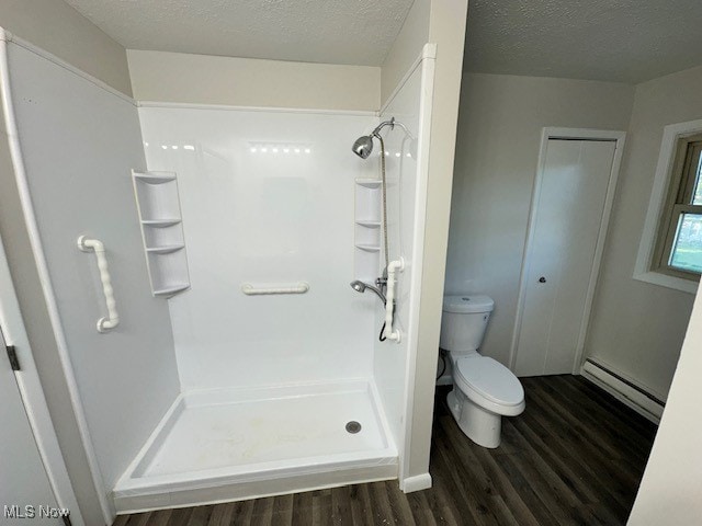 bathroom featuring a baseboard radiator, hardwood / wood-style flooring, toilet, and walk in shower