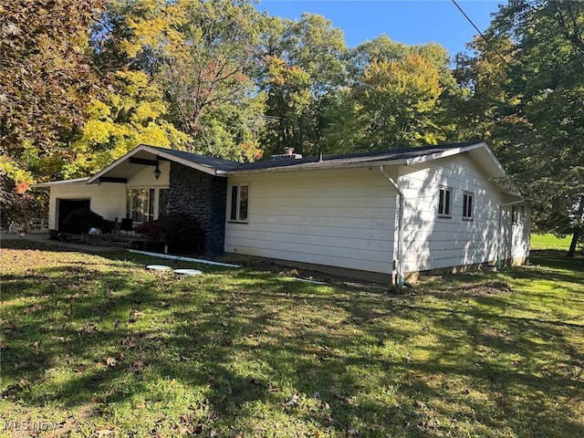 exterior space with a yard and a garage