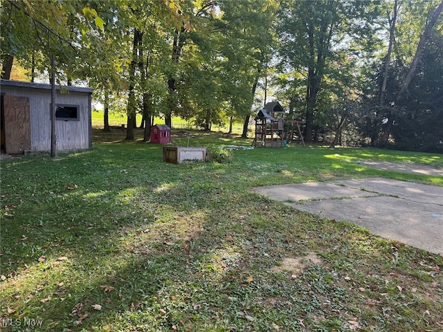 view of yard featuring a storage shed and a playground