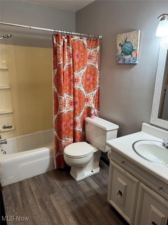 full bathroom with vanity, shower / tub combo, hardwood / wood-style flooring, and toilet