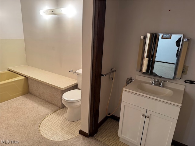 bathroom featuring toilet, vanity, a washtub, and tile patterned flooring