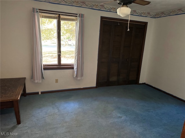 unfurnished bedroom with a closet, carpet flooring, and ceiling fan