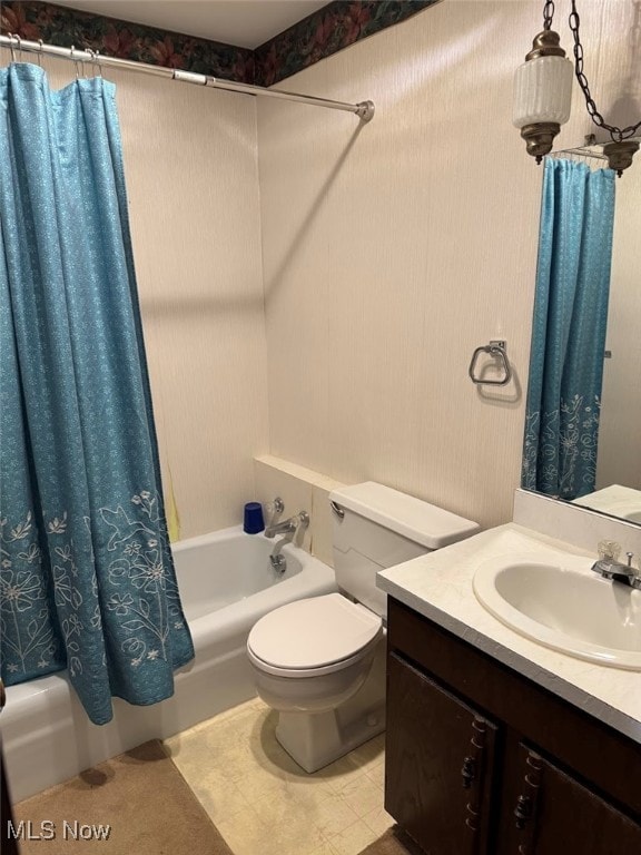 full bathroom featuring shower / bath combo with shower curtain, toilet, vanity, and tile patterned flooring