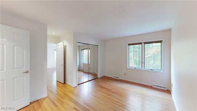 spare room with light hardwood / wood-style flooring