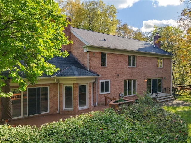 back of property with a patio