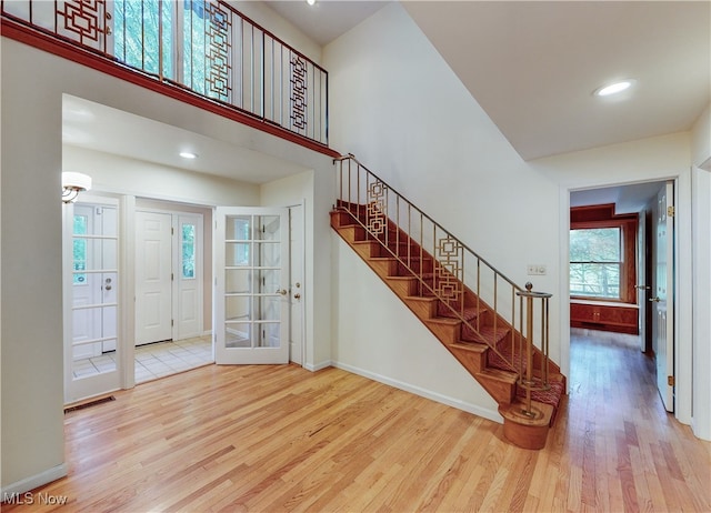 entryway with a high ceiling and hardwood / wood-style floors