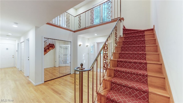 stairs featuring hardwood / wood-style floors