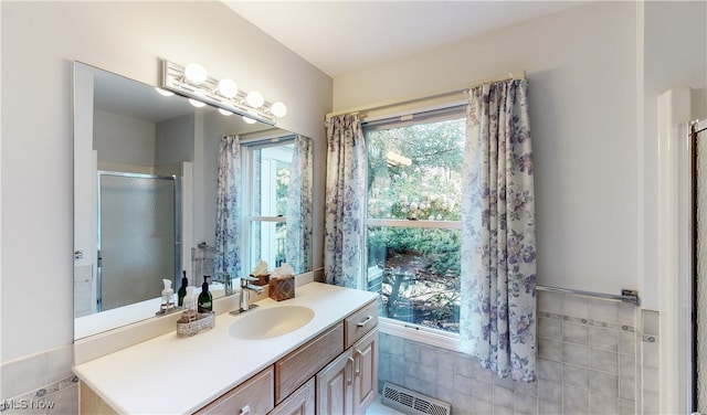 bathroom featuring tile walls, vanity, and plenty of natural light