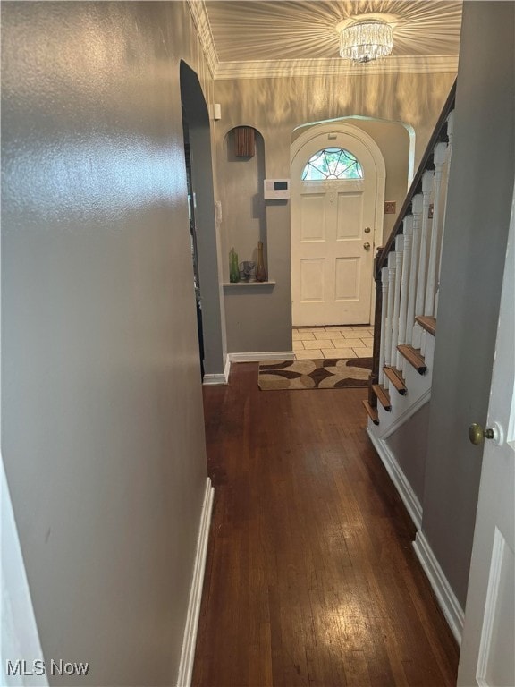 foyer with dark hardwood / wood-style floors and an inviting chandelier