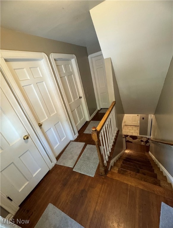 stairs featuring hardwood / wood-style floors