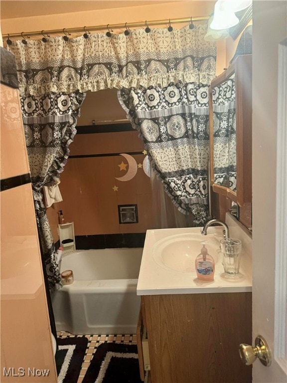 bathroom with vanity and a tub