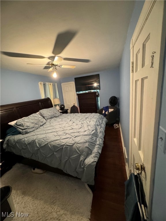 bedroom featuring dark wood-type flooring and ceiling fan