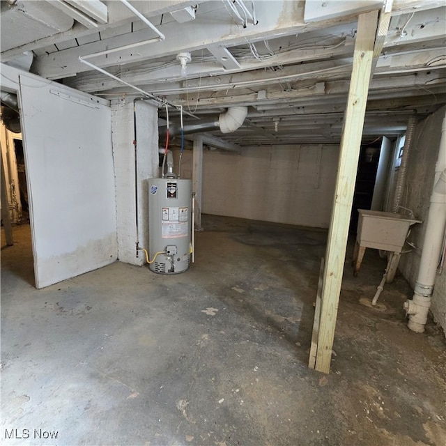 basement with water heater and sink