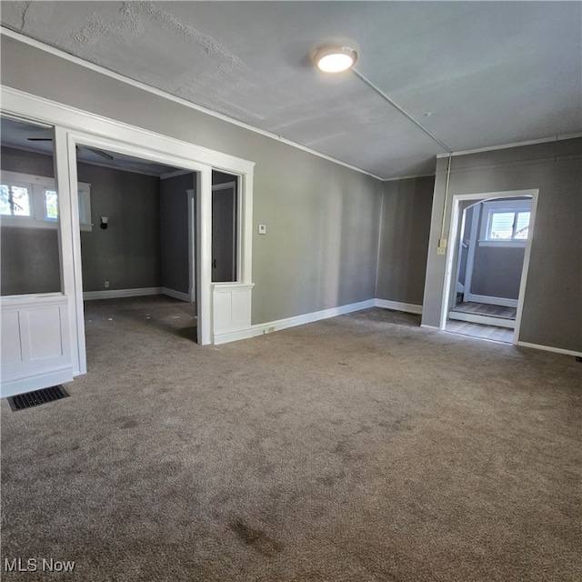 carpeted spare room with crown molding