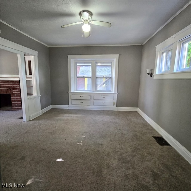 unfurnished bedroom with ceiling fan, carpet flooring, multiple windows, and ornamental molding