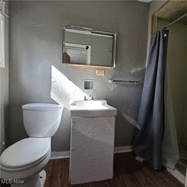 bathroom with vanity, hardwood / wood-style floors, curtained shower, and toilet