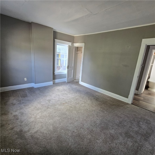 carpeted empty room featuring ornamental molding