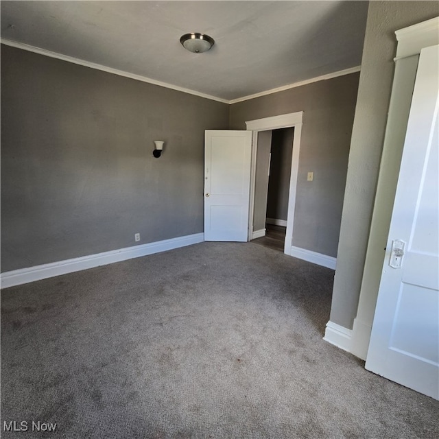 carpeted empty room featuring ornamental molding