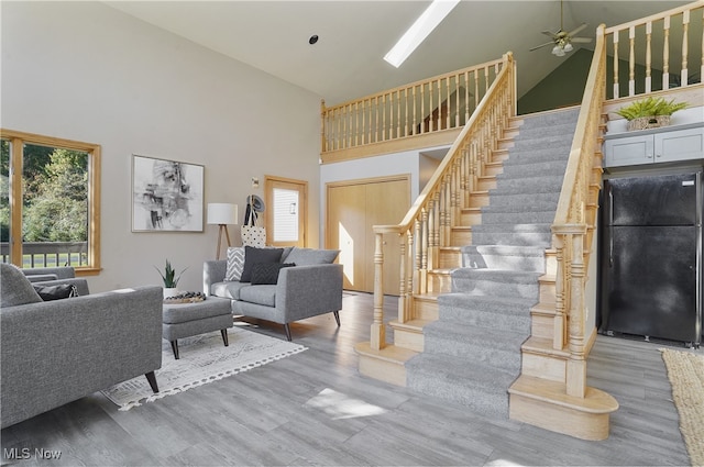 living room featuring hardwood / wood-style flooring, high vaulted ceiling, and a wealth of natural light