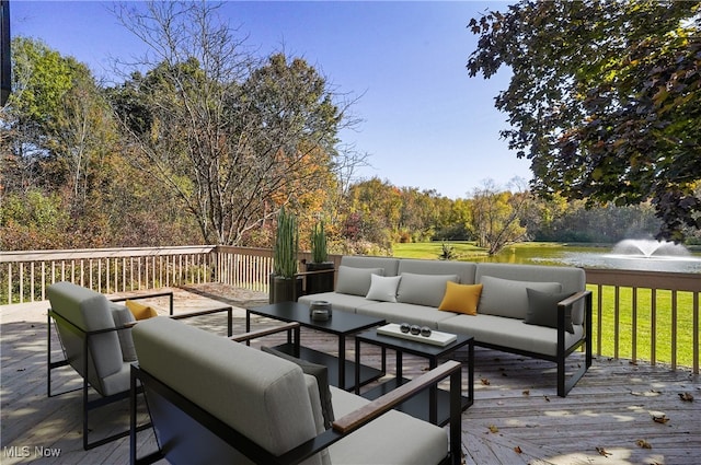 wooden deck with an outdoor living space and a water view