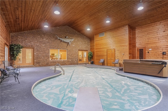 view of swimming pool featuring a hot tub