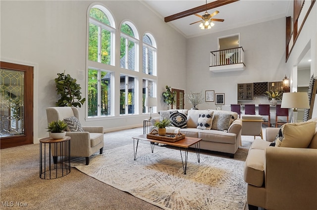 living room featuring beam ceiling, high vaulted ceiling, carpet flooring, and ceiling fan